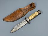 two knives are sitting next to each other on a table