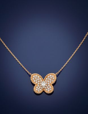 a diamond butterfly pendant on a gold chain