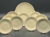 a set of six white dinner plates with dots on them