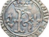 a silver coin with a crown on top of it