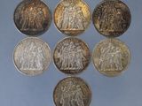 six types différents de pièces d'argent sur un fond bleu