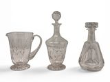 three glass vases and a glass jug sitting next to each other