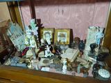 a glass display case with a lot of items on it