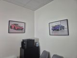 a picture of a car on the wall in the office