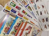 a pile of postcards sitting on top of a table