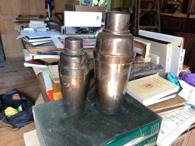 two vases sitting on top of a stack of books