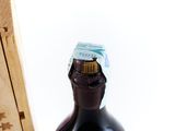 a bottle of wine sitting next to a wooden box