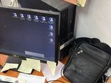 a desk with a computer, keyboard, mouse, and other items on it