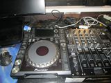a dj controller sitting on top of a table next to a laptop