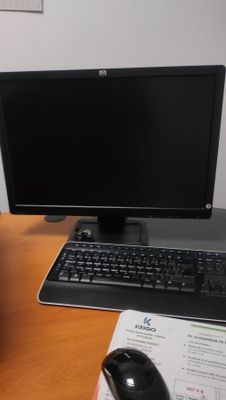 a desk with a computer, keyboard and mouse on it