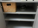 many plates and bowls on the shelves in the kitchen