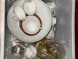 a white bowl with a saucer and spoons in it