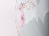 a close up of a plate with a flower on it