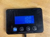 a digital clock on a table with a charger