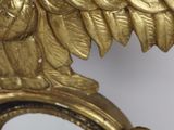 a mirror with an eagle on it and a mirror with a bird on it