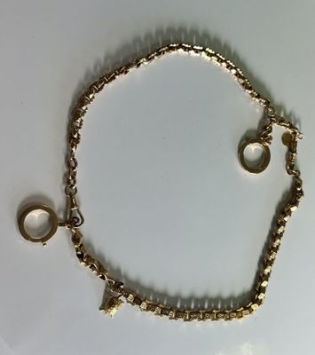 bracelet with two rings and two rings on it on a white surface