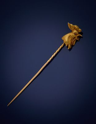 an old wooden stick with a flower on it against a blue background