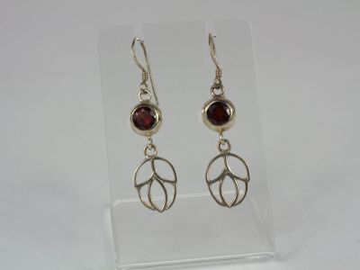 sterling silver earrings with garnetite stones on a clear acrylic stand