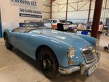 an image of a blue sports car parked in a garage