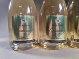 three bottles of champagne are lined up on a table