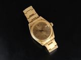 an image of a gold wrist watch on a black surface