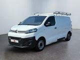 the white van is parked in a room with a white wall