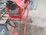 a red machine that is sitting on the ground