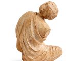 an image of a statue of a woman sitting on a stool