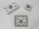 three pieces of porcelain on a white table