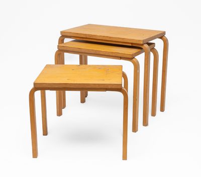 set of three nesting tables in the style of a school desk