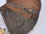a small wooden box with a gun inside of it