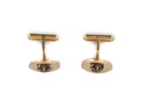 a pair of gold plated cufflinks on a white background