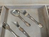 a tray that has silverware in it on a table