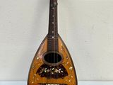 an image of a mandolin that is sitting on a table