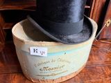 a black top hat sitting on top of a wooden box