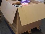 a large cardboard box sitting on a pallet in the middle of a room