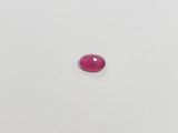 a red ruby gems on a white surface