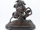 bronze statue of a man on a horse with a man on a horse