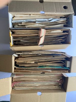 une pile de papiers dans une boîte en carton posée sur une table