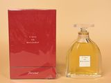 a bottle of perfume sitting next to a box on a table