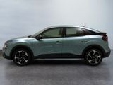 the rear view of a light blue suv parked in a room