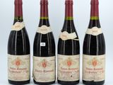 three bottles of wine are lined up on a white surface