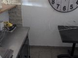 a clock that is on the wall in the kitchen