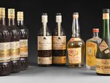several bottles of liquor are lined up on a table