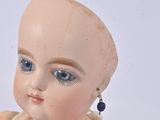 a small doll that is sitting on a table