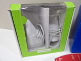 a box with a pair of baby shoes inside of it
