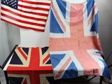 two british and american flags on a table in a room