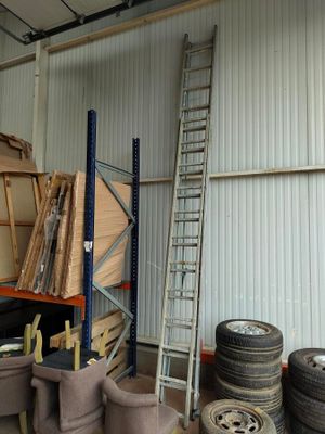 many tires and a ladder in a warehouse area