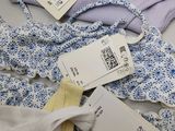 three women ' s underwear on a table with price tags on them
