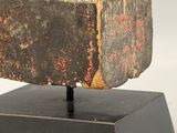 sculpture of a bird on a rock on a pedestal